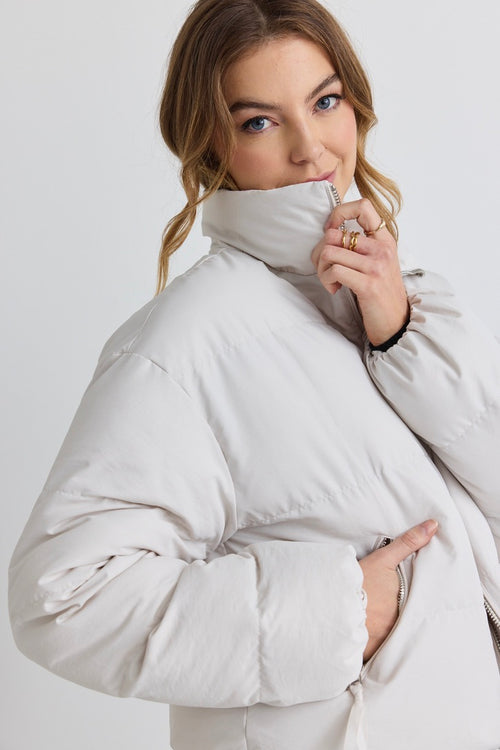 model wears a white puffer jacket