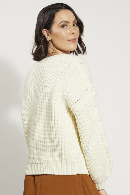 Model wears a white knit jumper