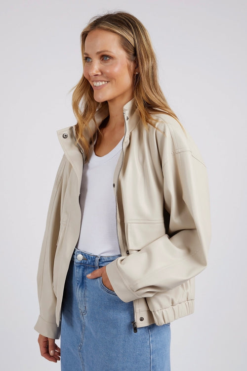 model wears a beige jacket