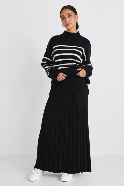 model wears a black knit maxi skirt