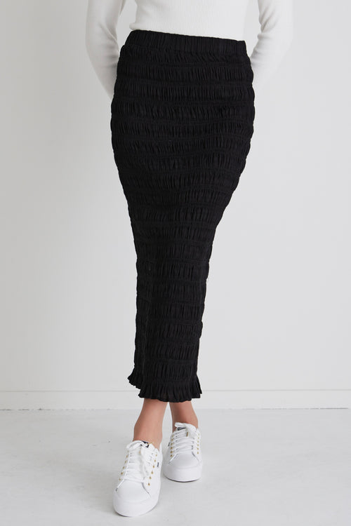 model wears a black maxi skirt