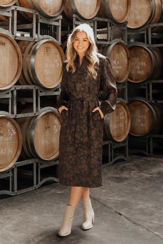 model wears a brown floral long sleeve midi dress