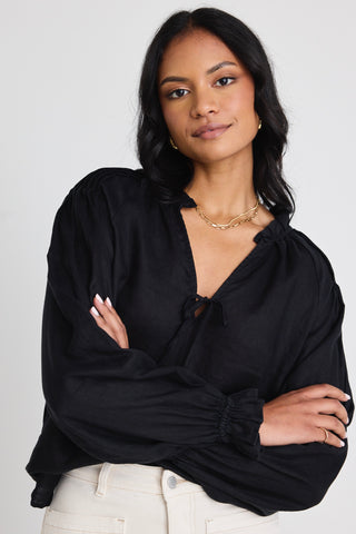 model wears a black linen long sleeve top