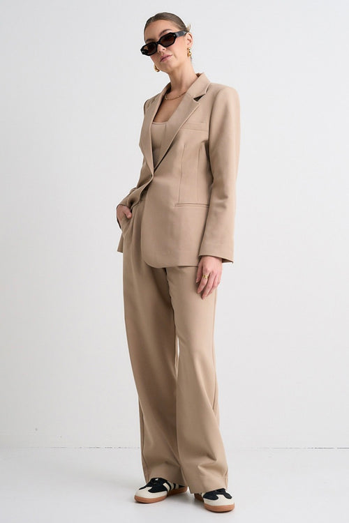 model wears a brown suit