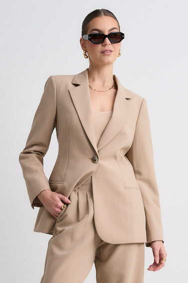 model wears a brown suit
