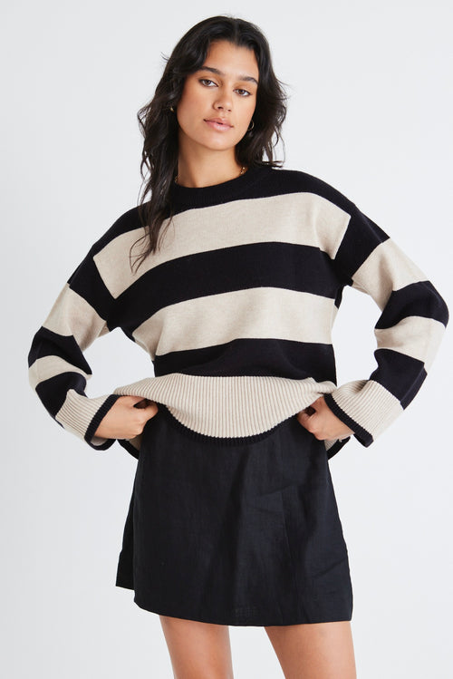 model wears a beige and black stripe knit