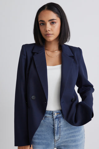 model wears a navy blue blazer