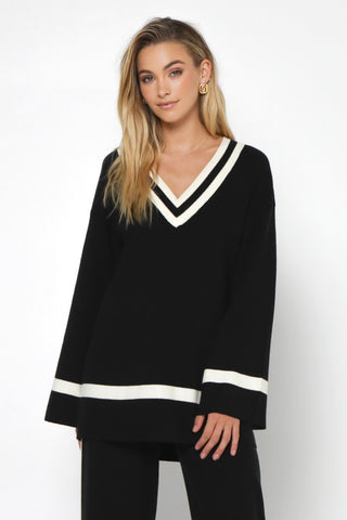 model wears a black knit 