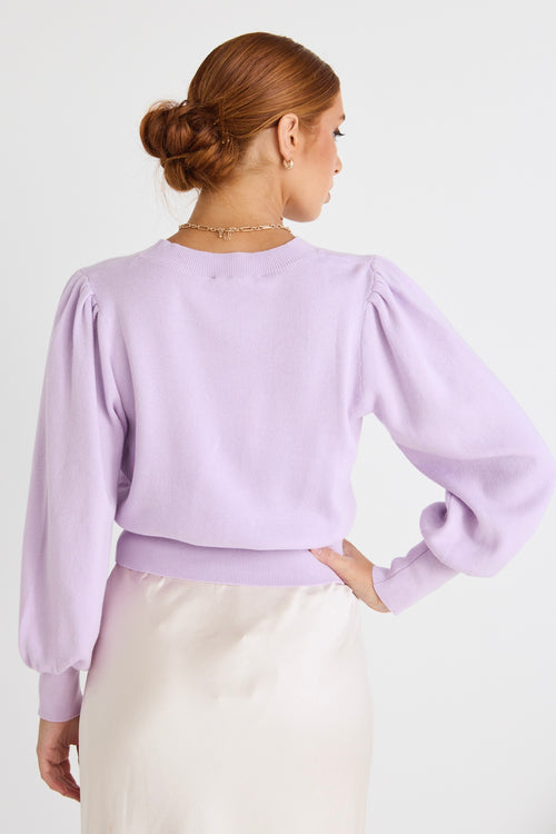 model wears a purple knit