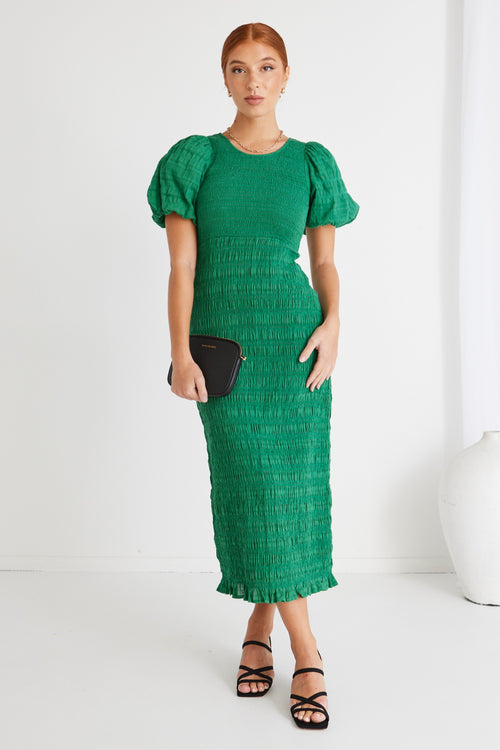 model wears a green midi dress