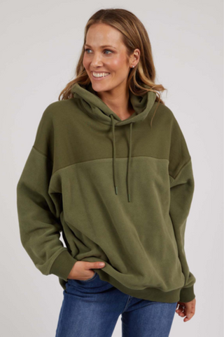 woman wearing green hoodie and blue jeans