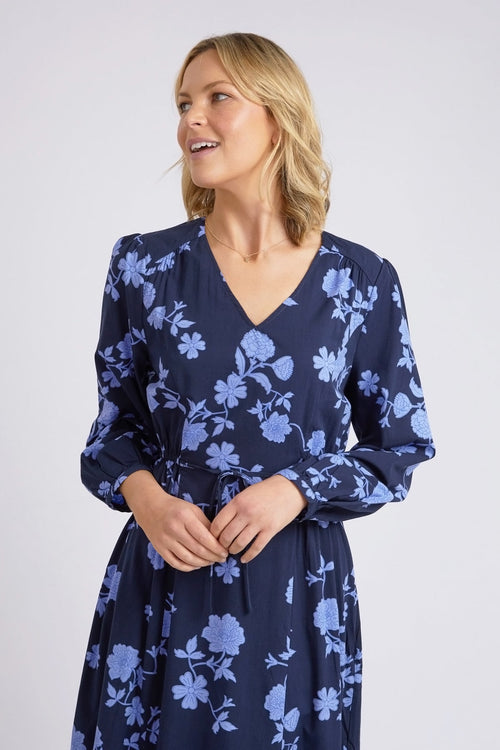 model wears a blue long sleeve floral dress
