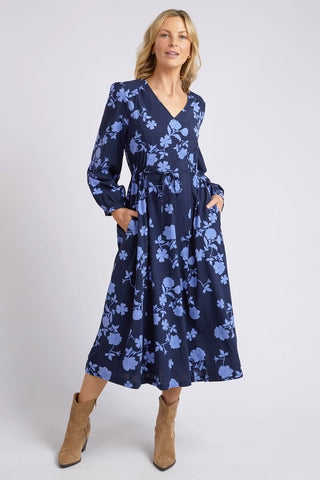 model wears a blue long sleeve floral dress