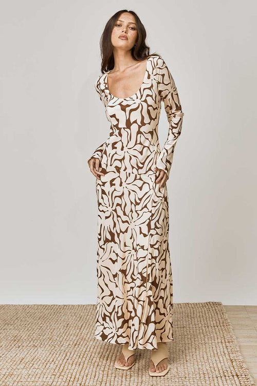 model wears a brown floral long sleeve dress