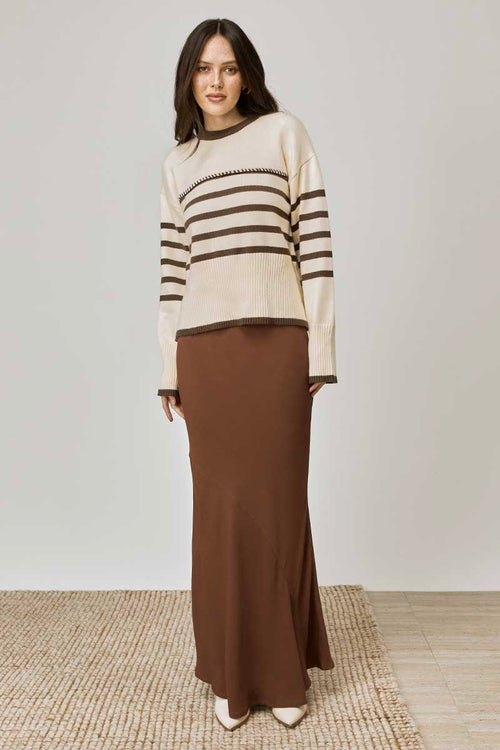 model wears a beige tan stripe knit