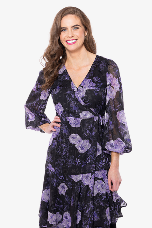 Model wearing black and purple floral long sleeve midi dress