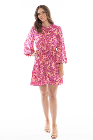 model posing in pink floral long sleeve mini dress