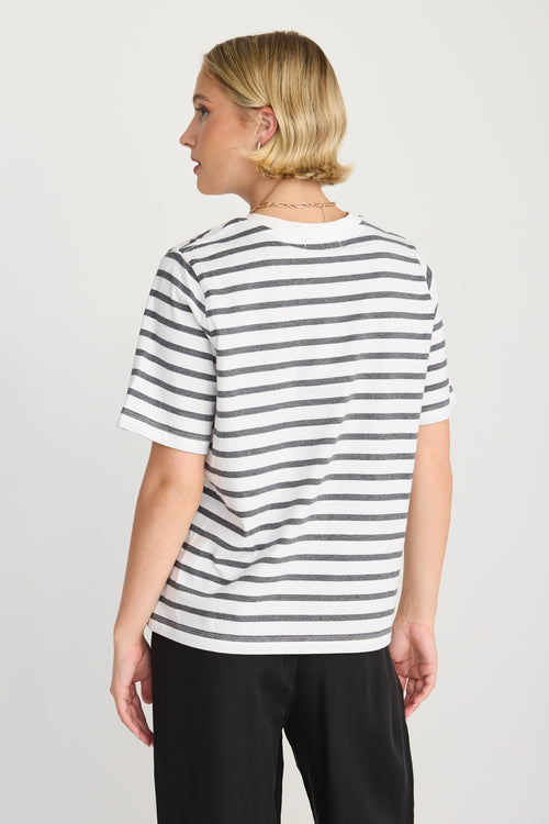model wears a black and white stripe tee
