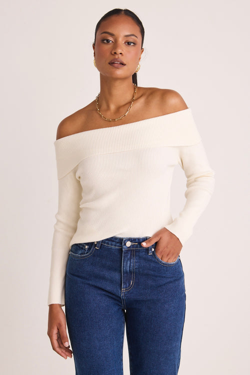 model wears a white off the shoulder top
