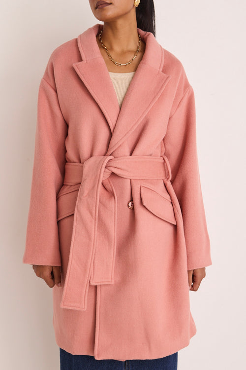 model wears a pink coat