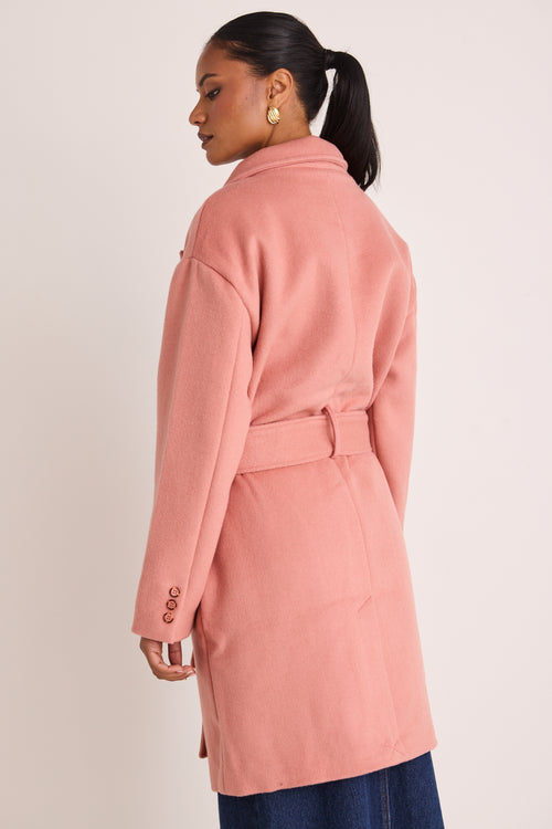 model wears a pink coat