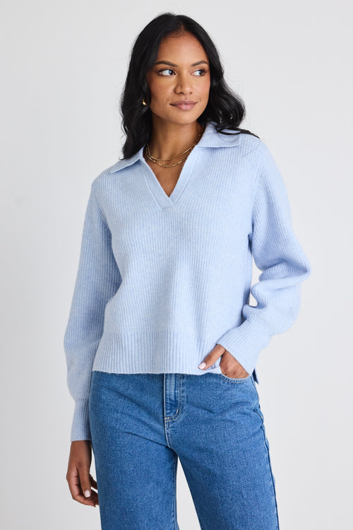 model wears a blue knit jumper