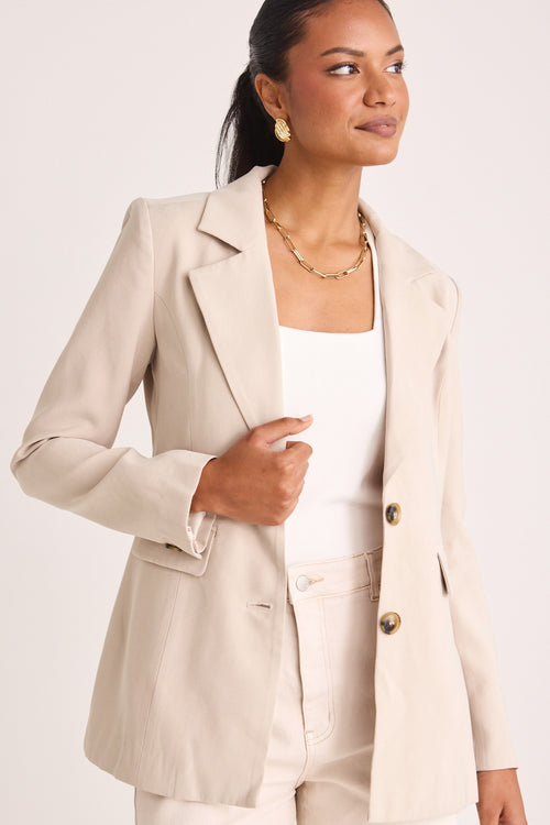 model wears a beige blazer