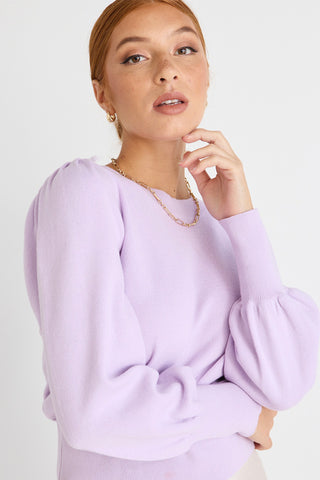 model wears a purple knit
