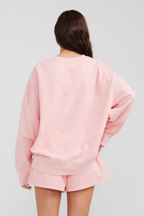 model wears a pink jumper