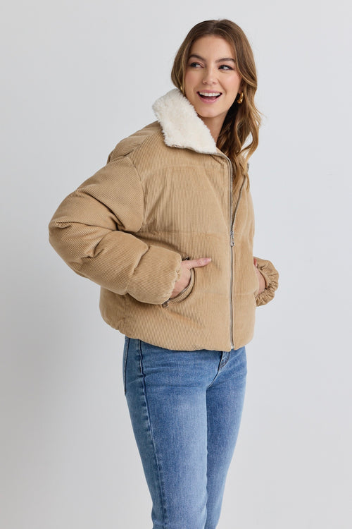 model wears a brown puffer jacket